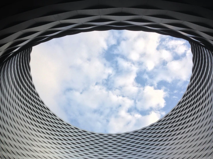 the reflection of clouds is in a window on a building