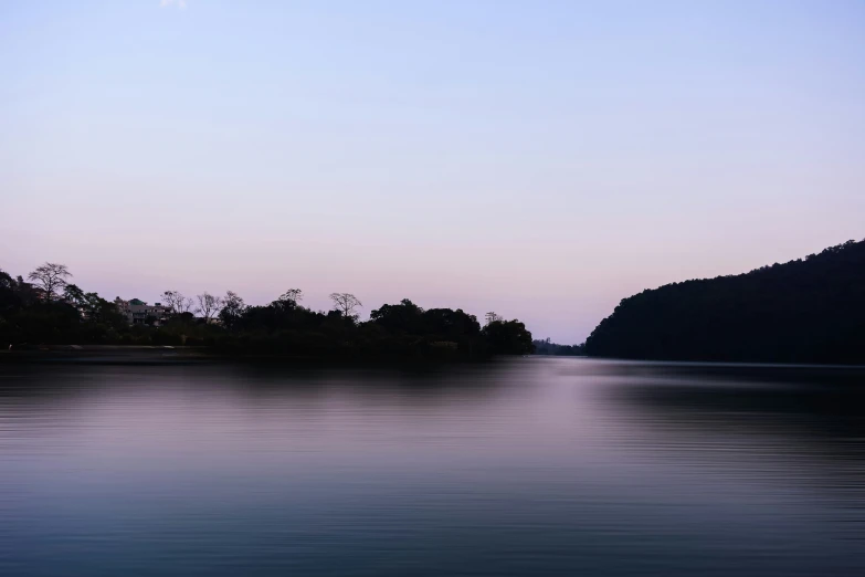 the moon over the mountain peaks in the distance