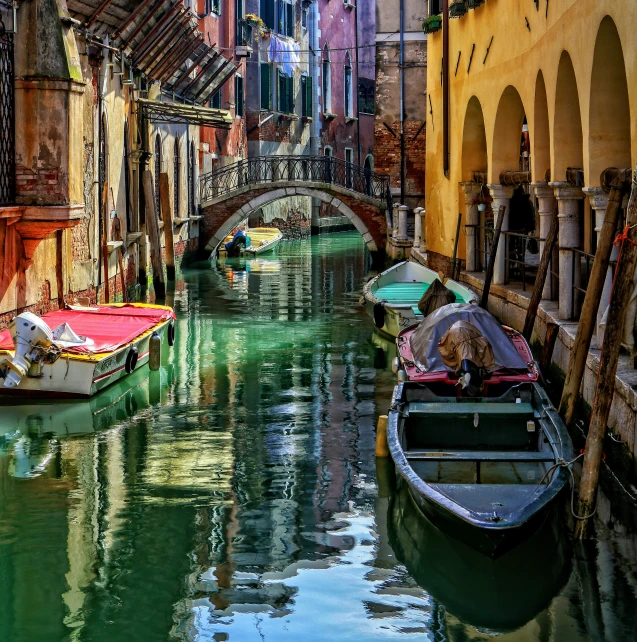 a waterway that has several different boats floating along it