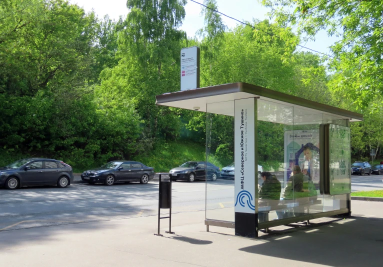 a bus stop in the middle of some parking spaces