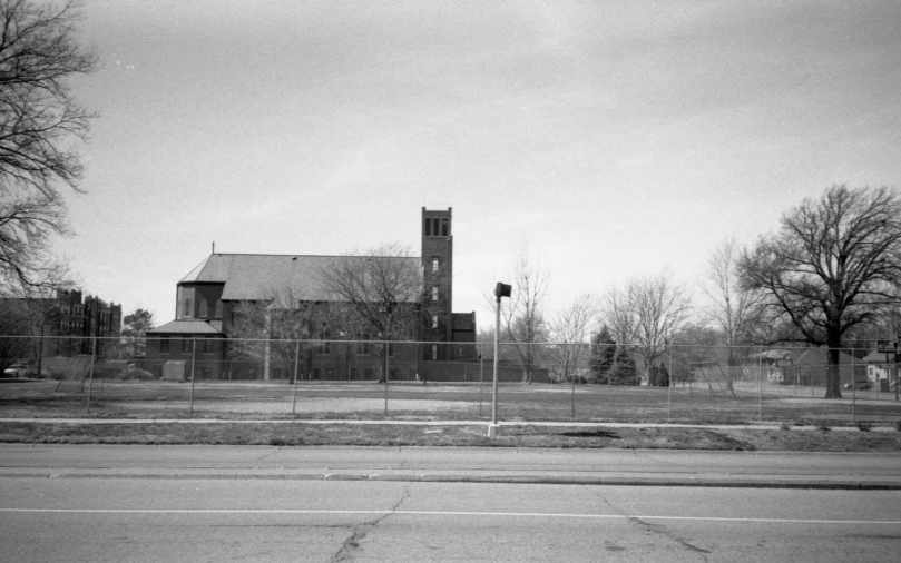black and white po of a church behind a fence