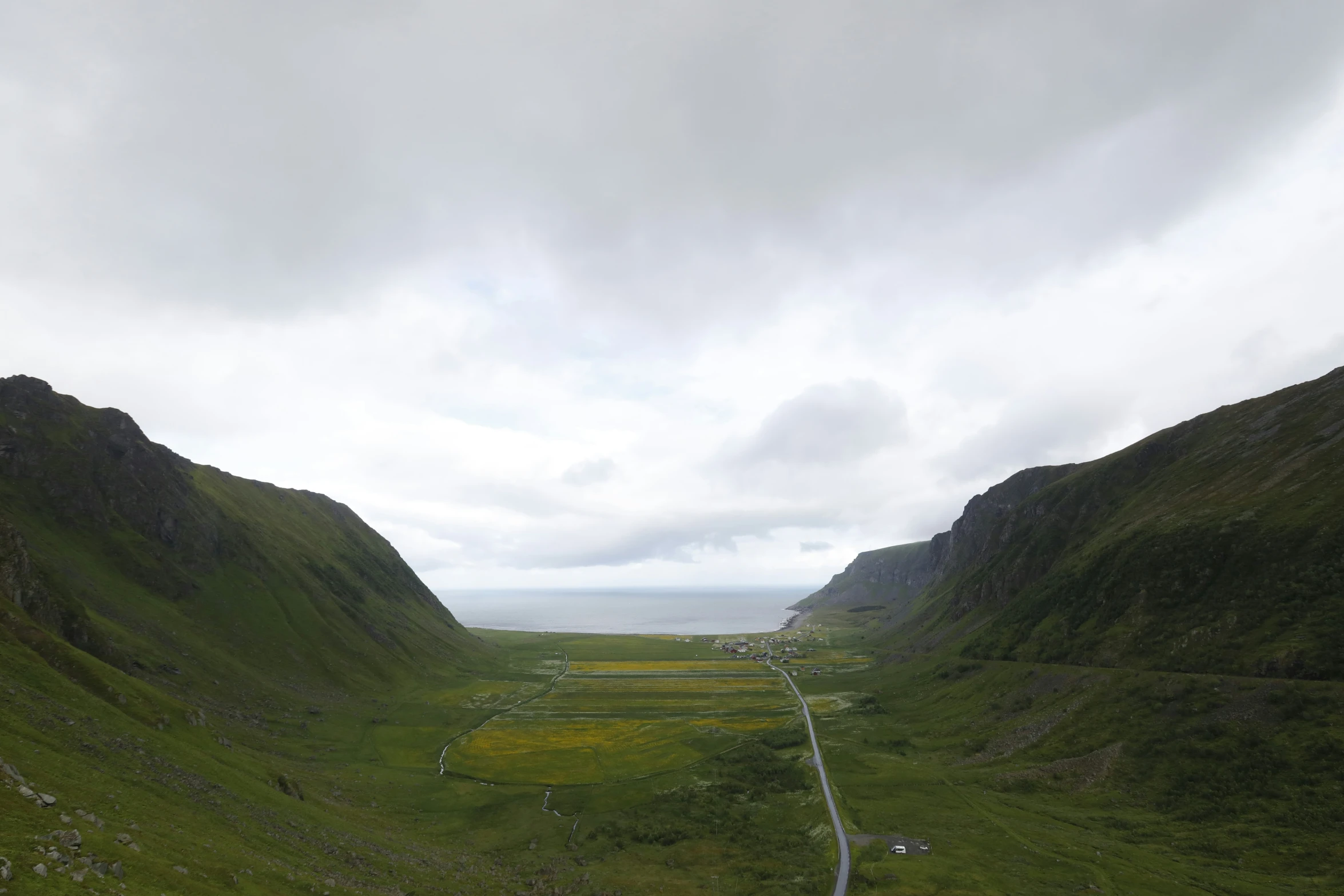 looking down at the valley with tall mountains in the distance