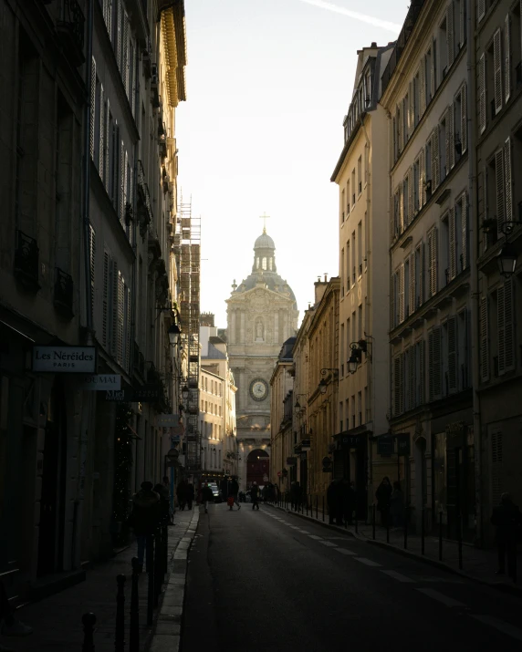 a city street with people walking down it