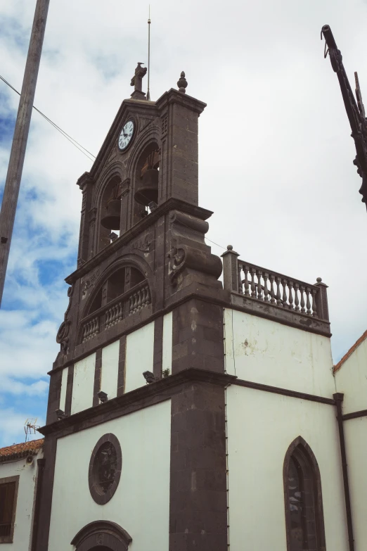 a white and gray church and some power lines