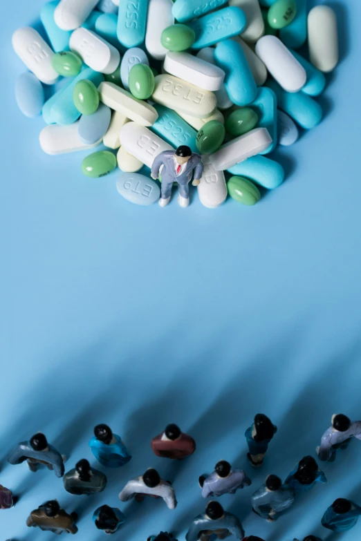 a bunch of toy figures with pills above them