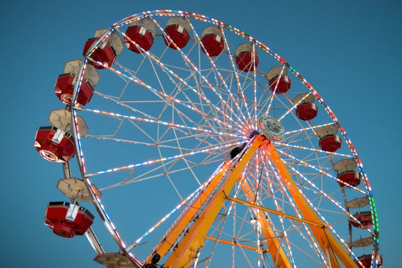 a large ferris wheel sits in the sun