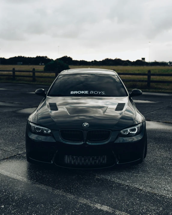 the bmw vehicle parked in a lot with its hood down