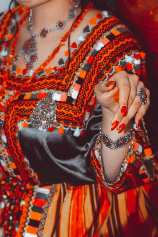 a woman holding onto soing with many different beads