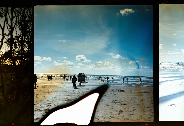 a po of people at the beach, taken with a camera phone