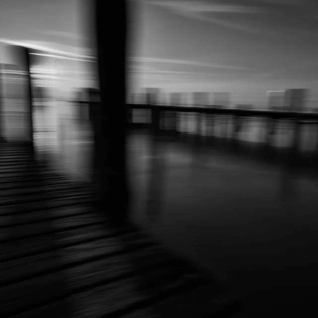 a black and white pograph of the pier in the evening