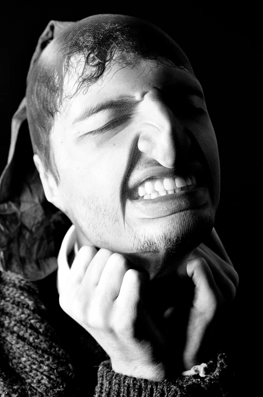 a black and white image of a man smiling