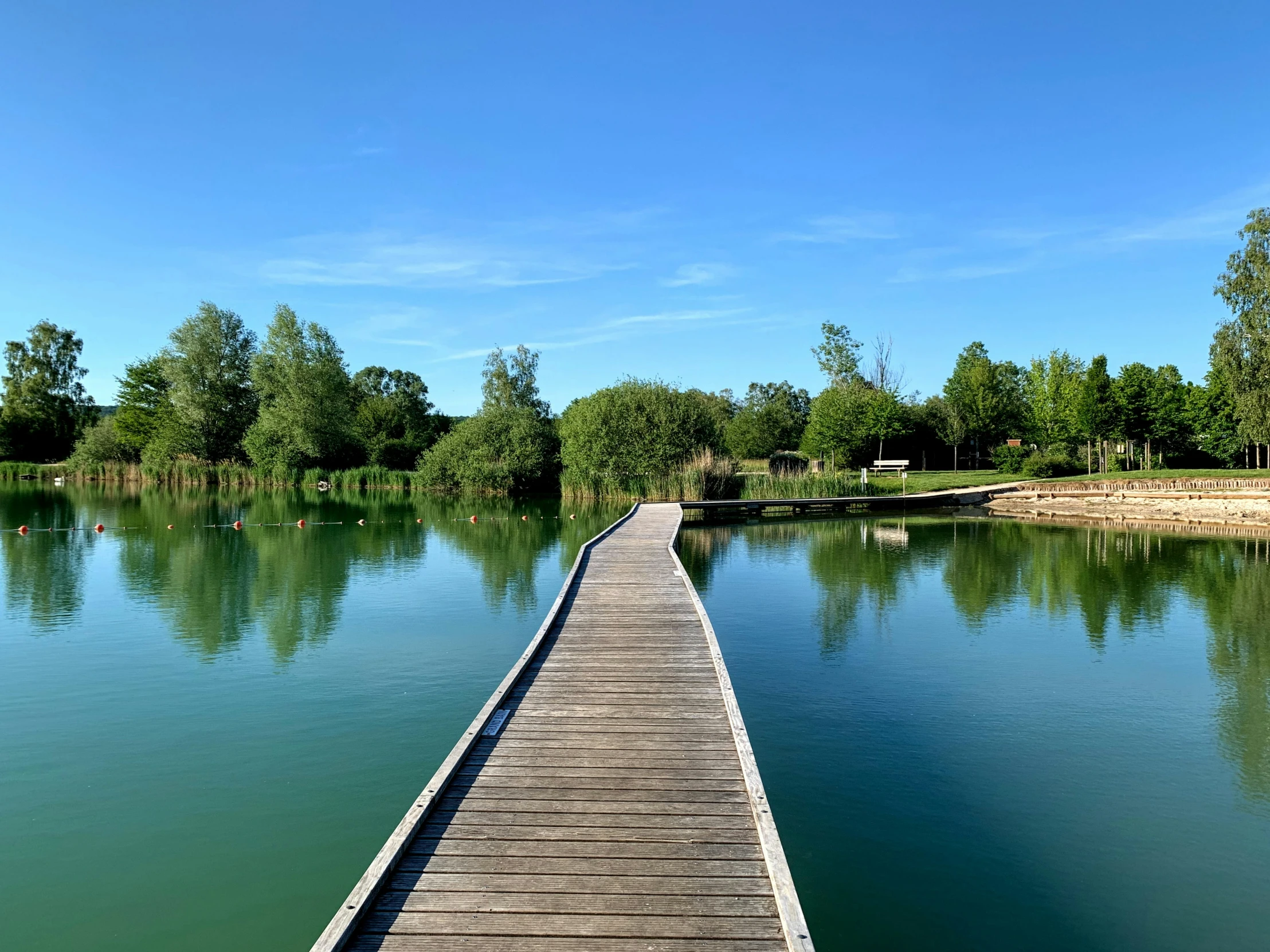 there is a wooden dock stretching out into the water