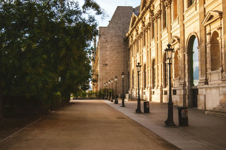 an empty city street in front of a large building