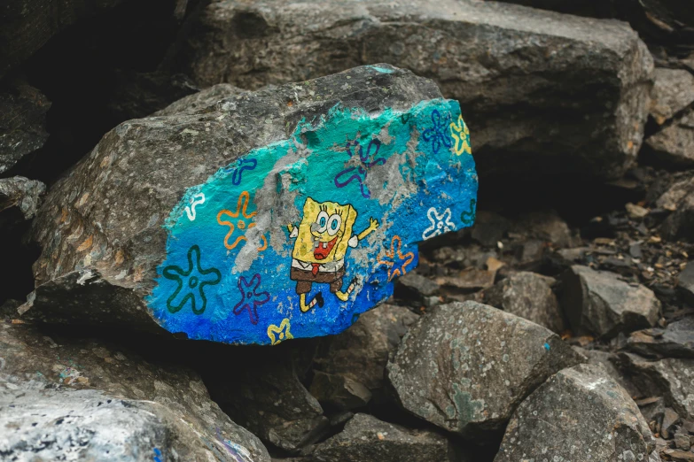 there is a rock painted with spongebob on it