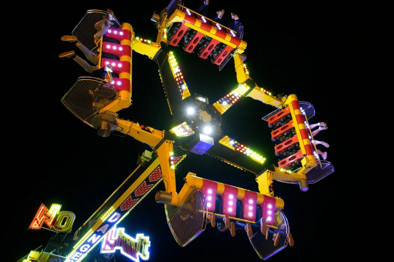 the ferris ride at an amut park lit up with bright lights