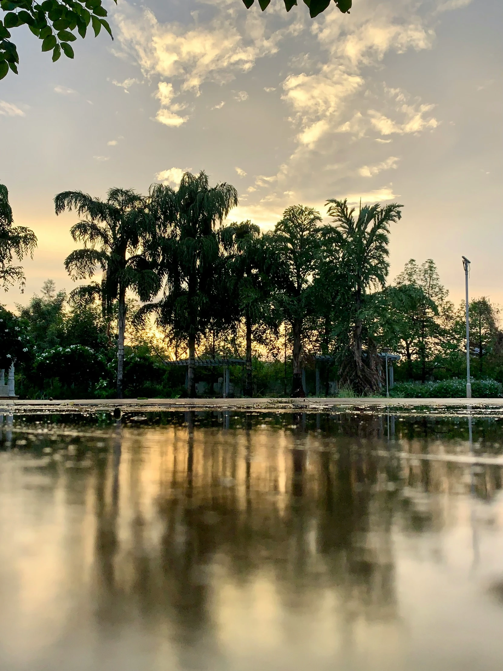 a cloudy day reflecting light on a wide lake