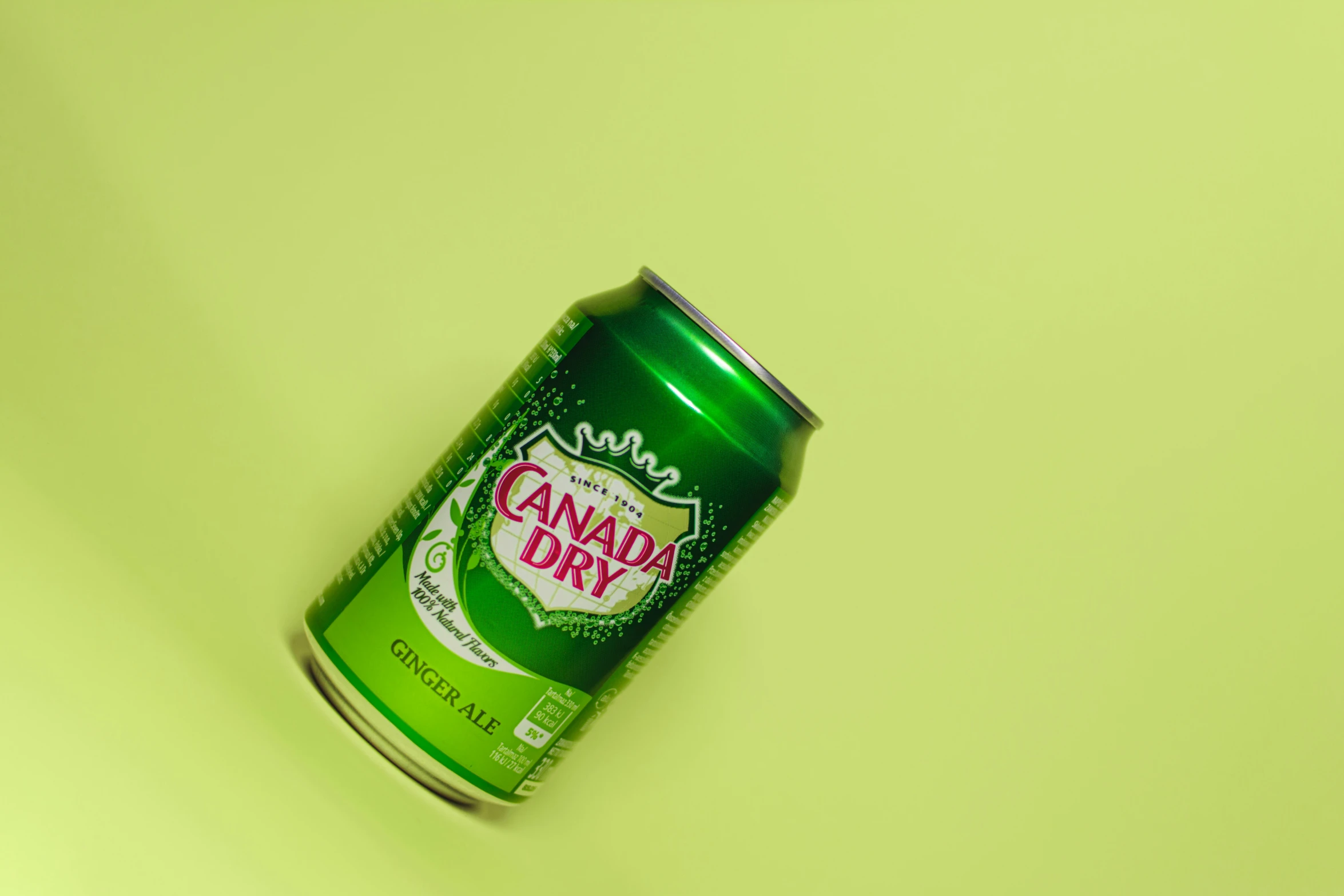 an open can of canadian dry on a yellow background