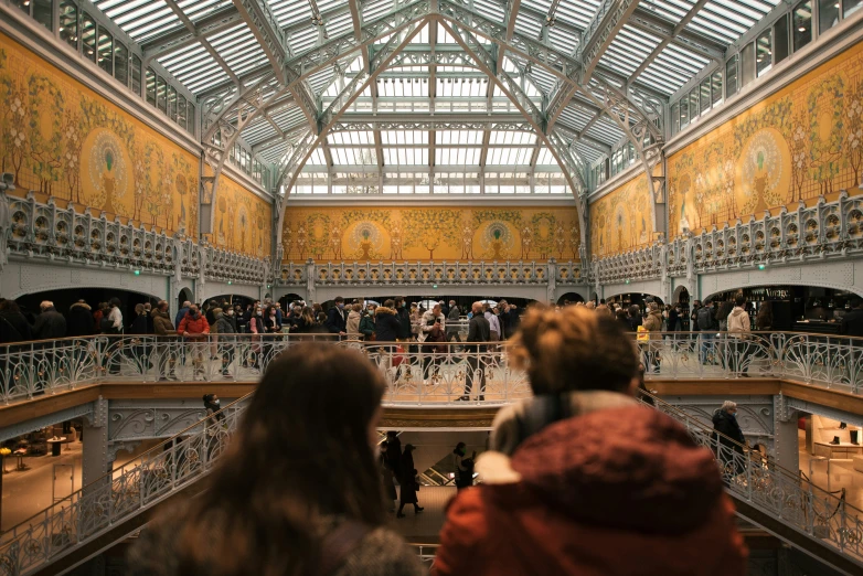 people at the top of the escalators on an open building