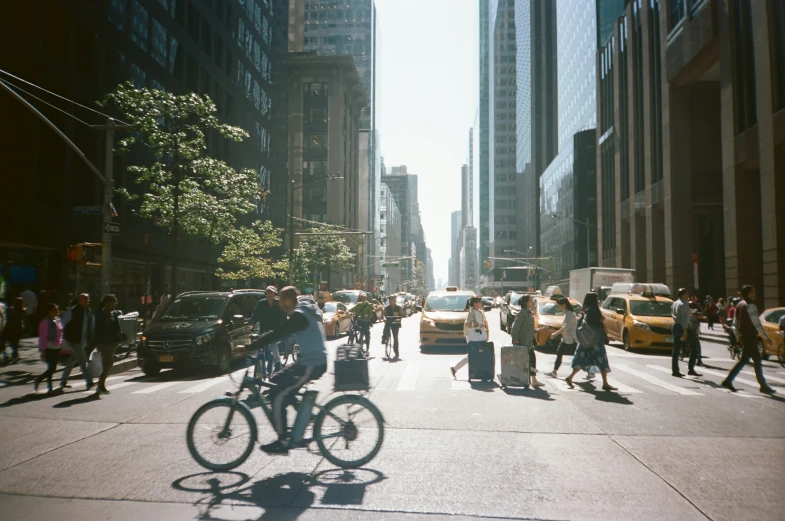 a crowd of people are crossing the street