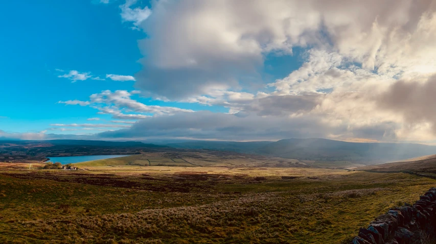 the beautiful landscape on the hills is dotted by clouds