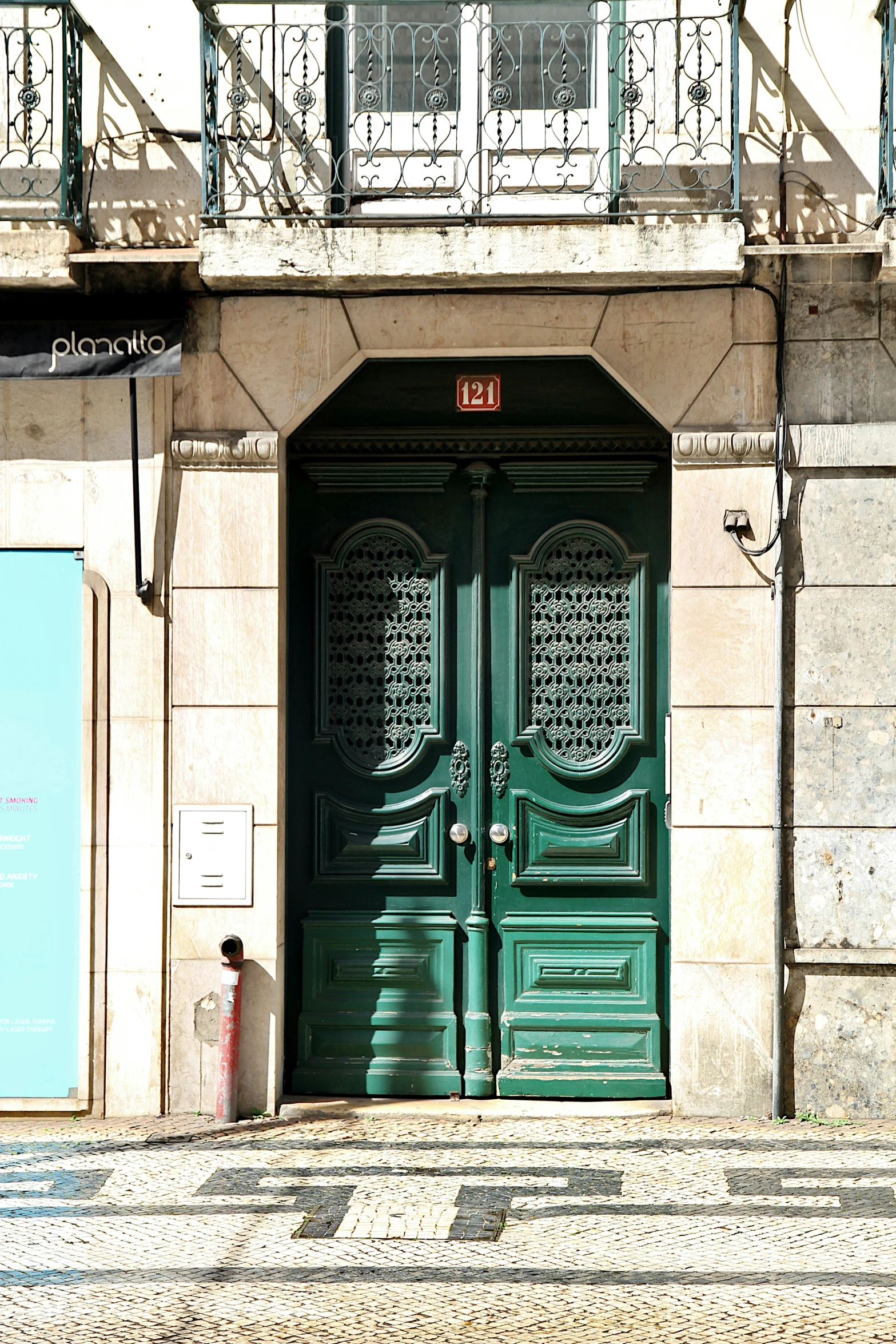 an image of a green building with double doors