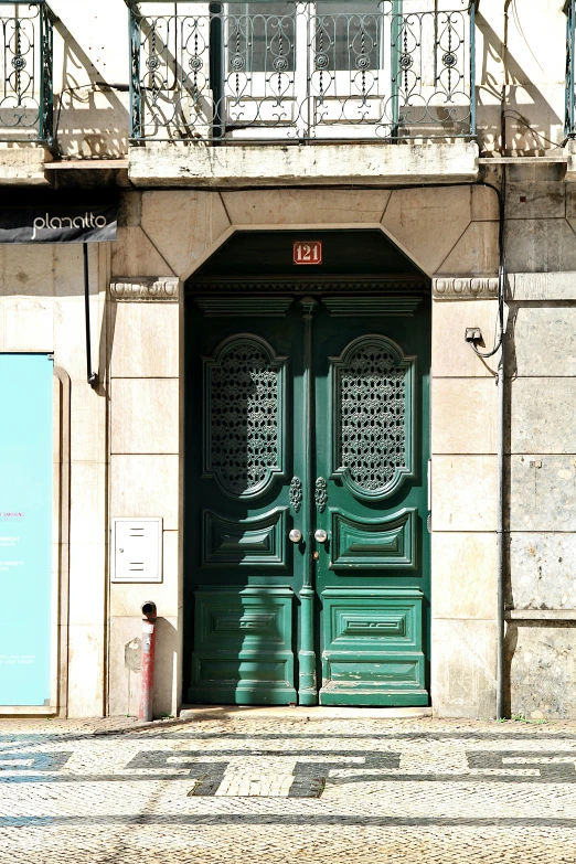 an image of a green building with double doors