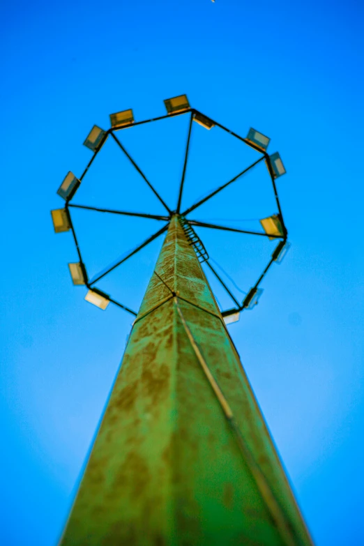 a ferris wheel is sitting on top of a tall building