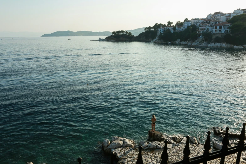 some sea cliffs water and a small town