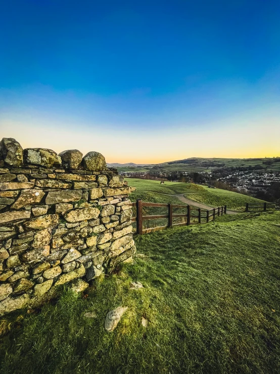 a stone wall sits on top of a hill