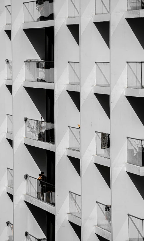 a building with balconies casting long shadows