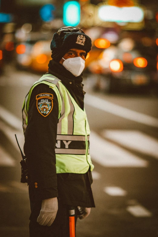 man standing near street light wearing a police vest