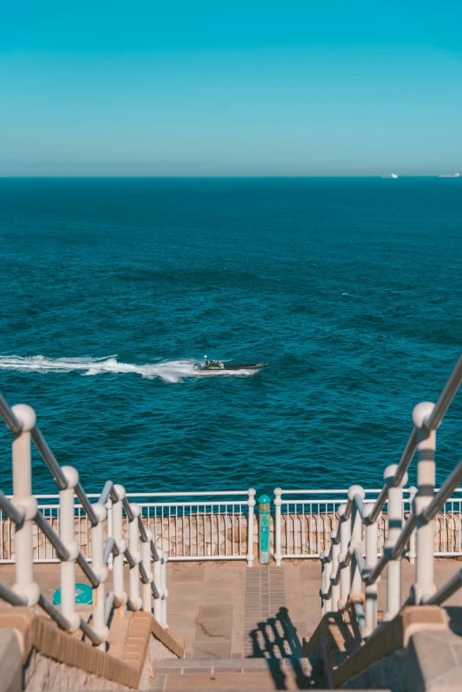 there is a boat going by behind the railing