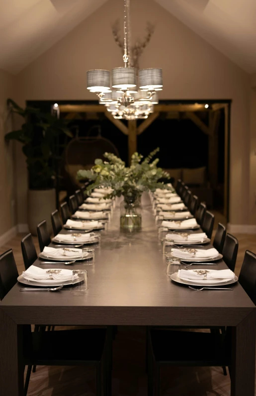 an empty conference table is set with dinnerware