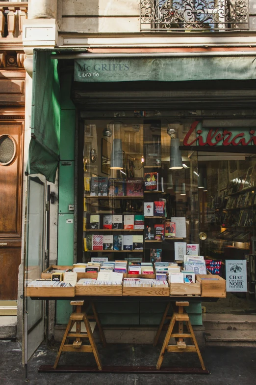 a table with many books on top in front of a store