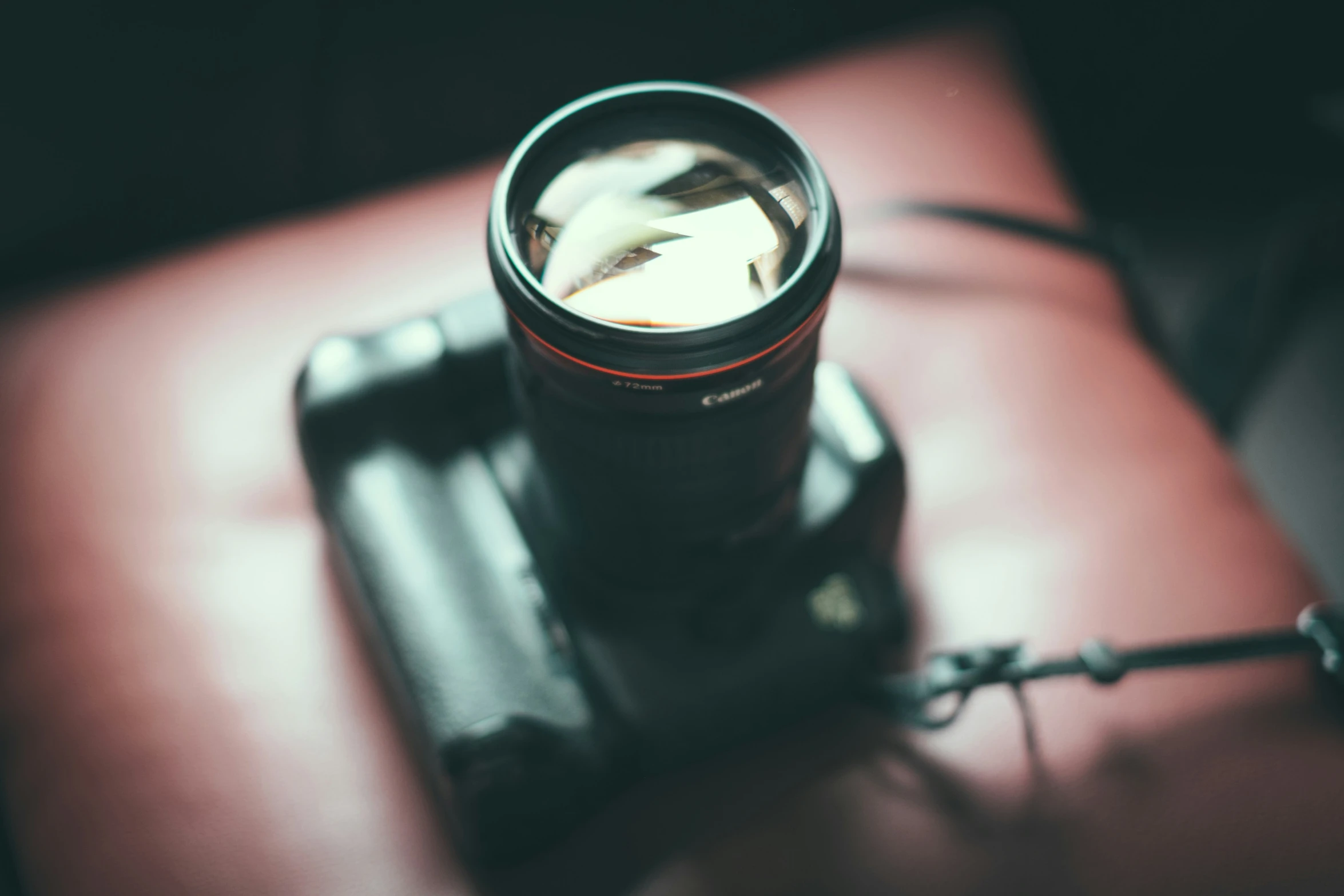 a camera lens with reflection over a dark background