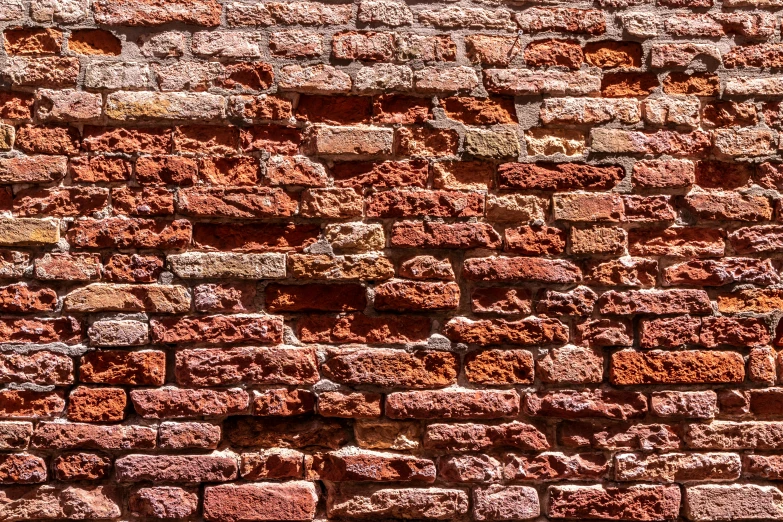 a brick wall has red and green colors