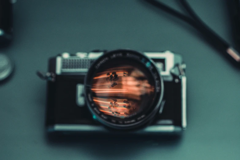 a camera with lens sitting on top of a table