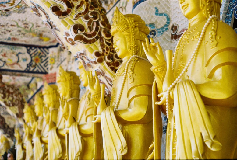 some yellow statuettes and some ornate wall paper