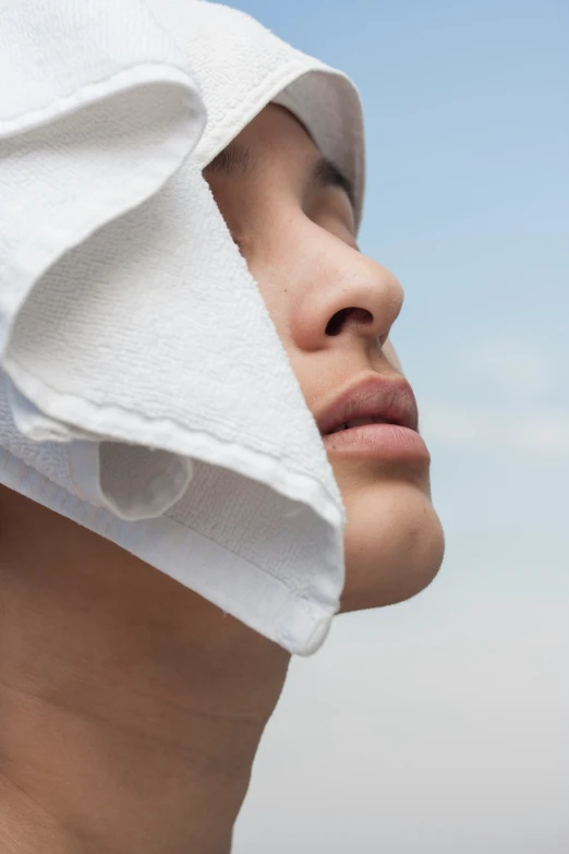 a woman's head under a white towel