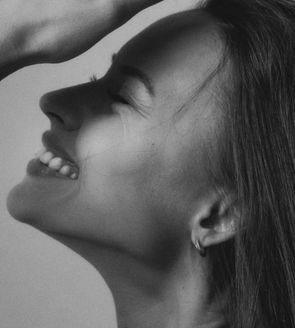 a woman's face close up with her hair blowing