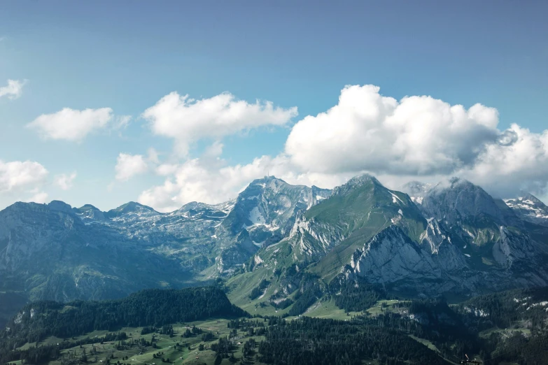 the sky over the mountains is filled with clouds