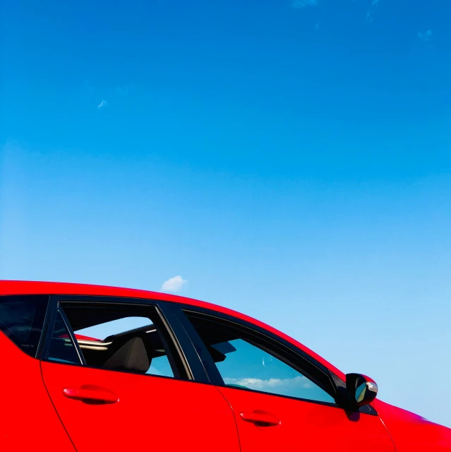 an orange sports car on road with blue sky background