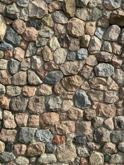 a stone wall with different colors and sizes of rocks