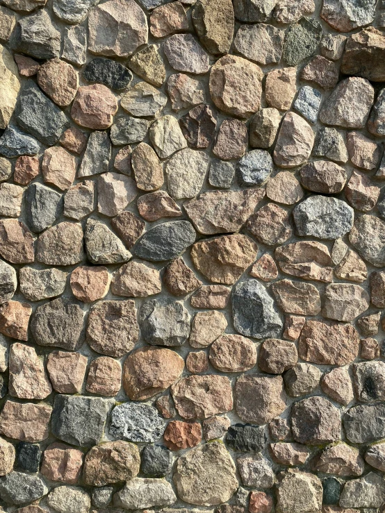 a stone wall with different colors and sizes of rocks