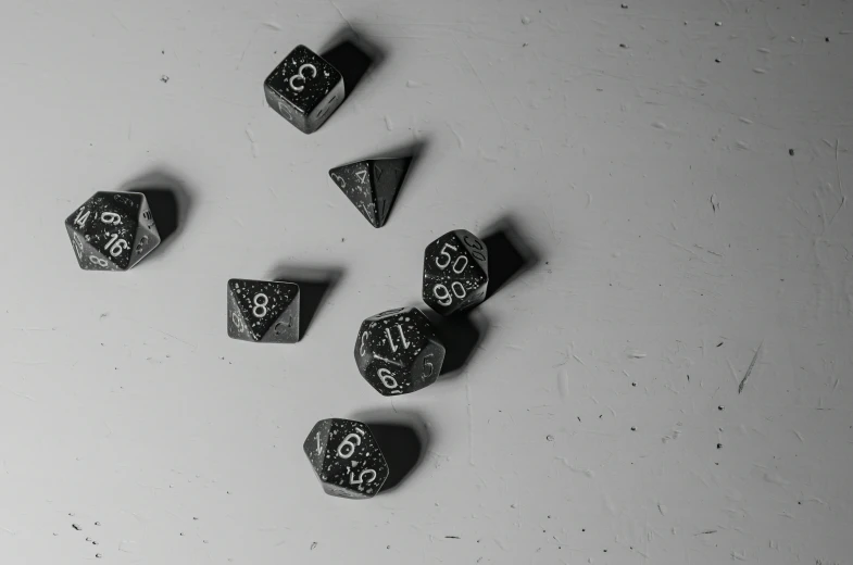 small rocks are lying on the table with black numbers on them