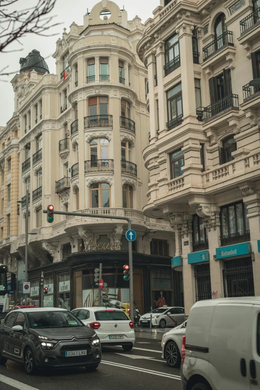 many different street cars in front of some buildings