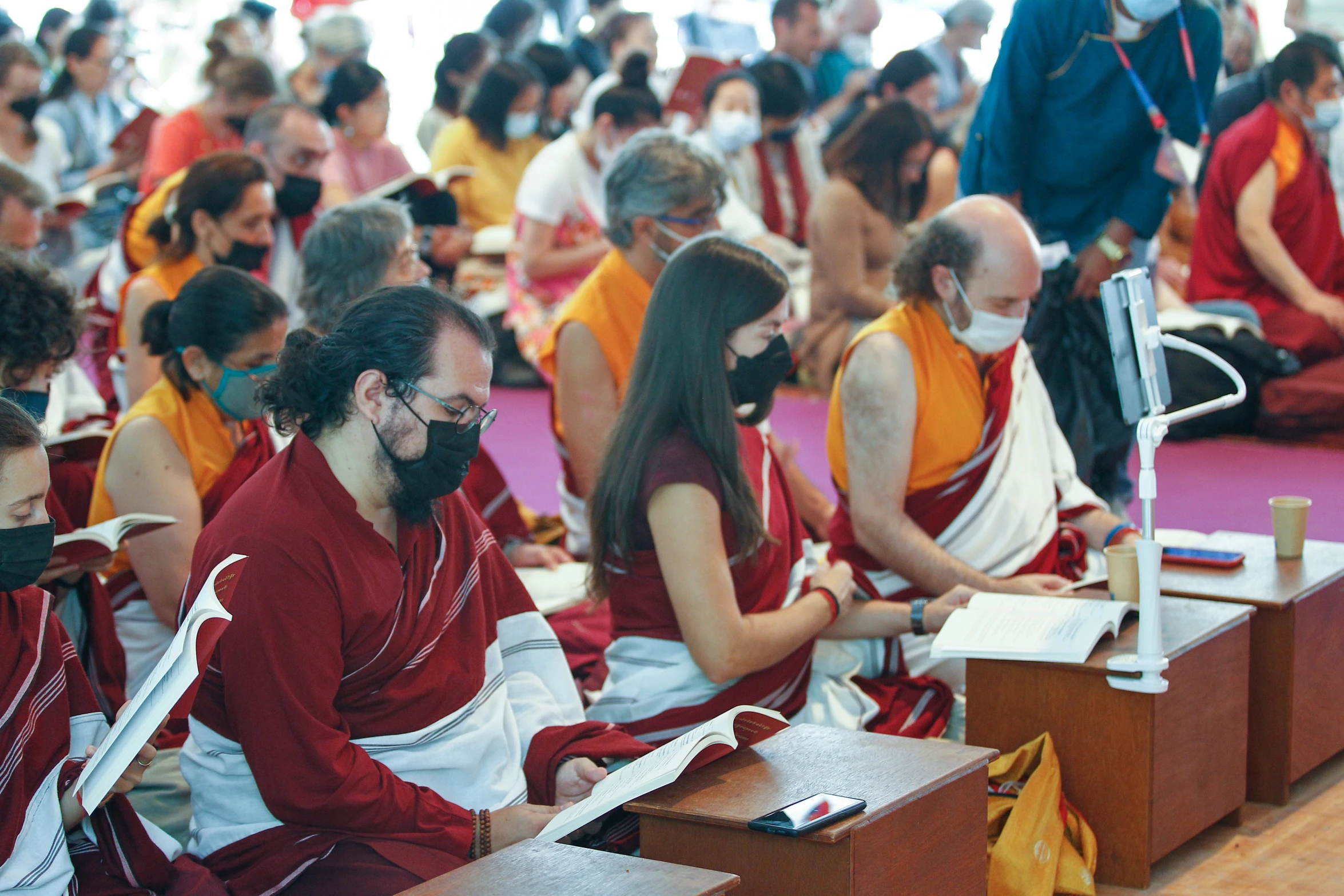 several people sitting in a room and looking at papers