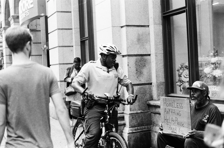 the bicyclist is waiting on his turn for the bus