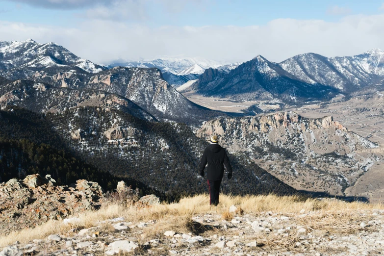 the man standing on top of a hill is taking pictures