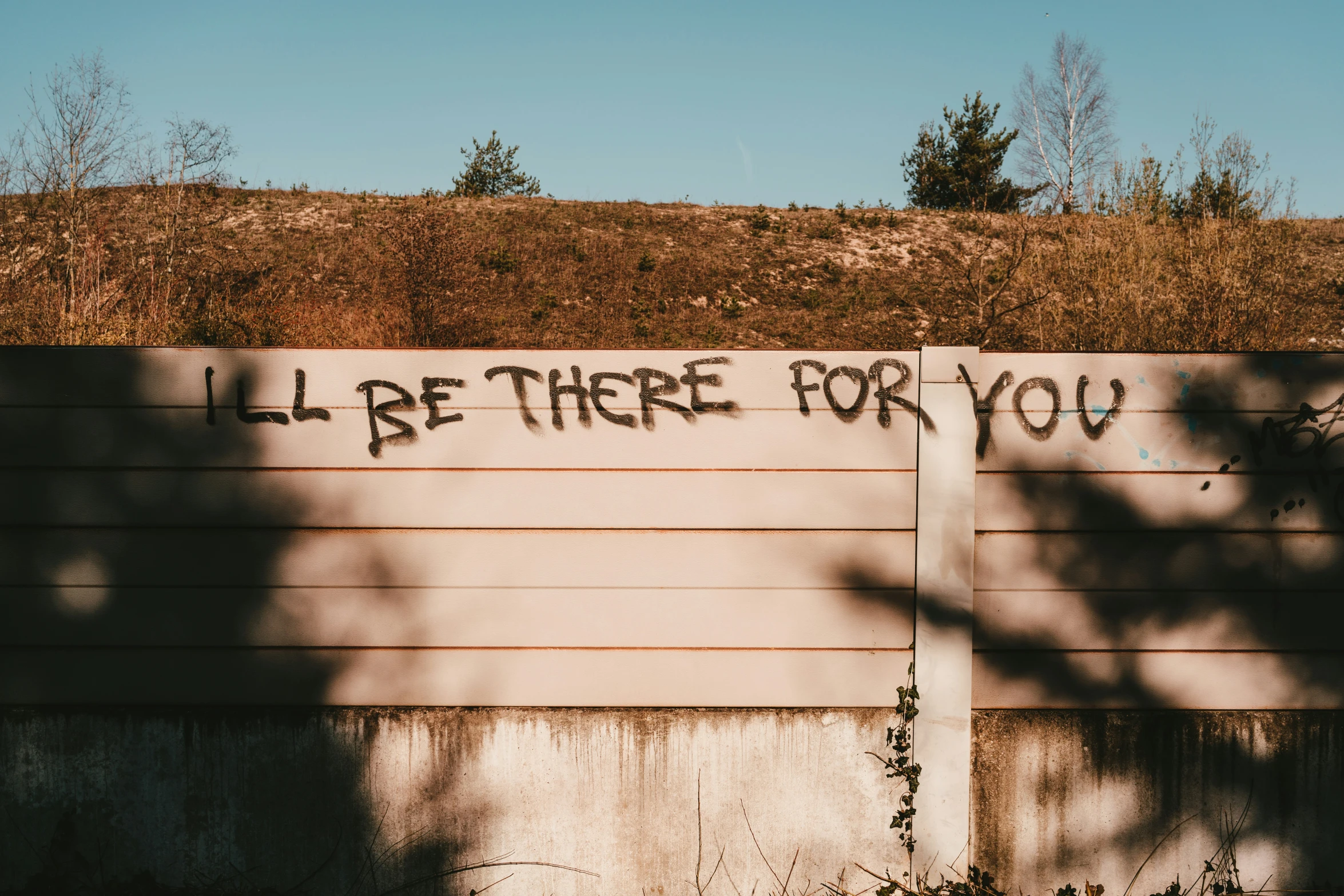 a fence with writing all be there for you on it